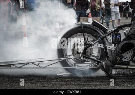 A drag racing motorcycle performs a burnout to warm the rear tire Stock Photo: 36053511 - Alamy