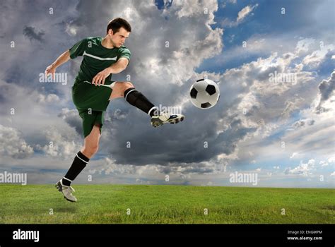 Young soccer player kicking ball outdoors Stock Photo - Alamy