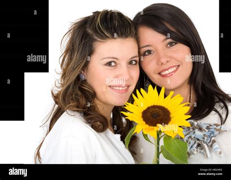 beautiful sisters portrait with a yellow sunflower - isolated over a white background Stock ...