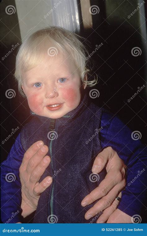 A baby with rosy cheeks editorial image. Image of held - 52261285