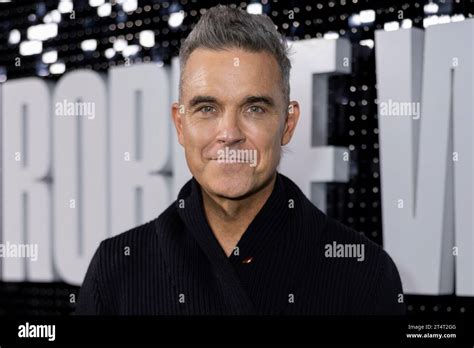 Robbie Williams poses for photographers upon arrival at the premiere ...