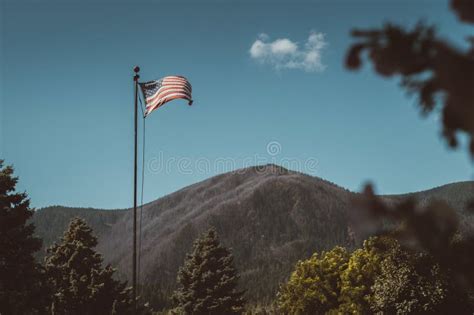 American And Colorado Flag Waving In The Wind With Mountains In Stock ...