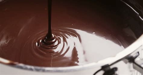 Melted chocolate or chocolate sauce flowing in a pan or a pot. Stock Video Footage - Storyblocks