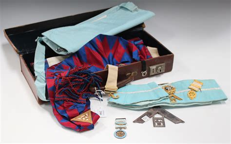 A group of Masonic regalia, including medals and badges, within a leather case.