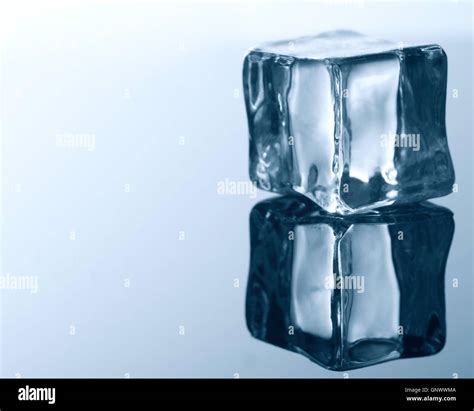 ice cube on blue background Stock Photo - Alamy