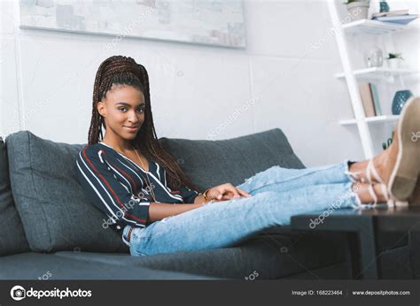 Woman relaxing on couch at home — Free Stock Photo © VitalikRadko #168223464