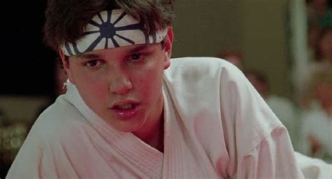 a young man in a kimono with an eye patch on his forehead looking at ...