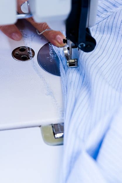 Premium Photo | Hands work a sewing machine.