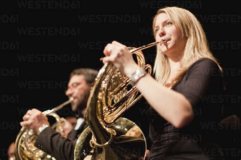 French horn players in orchestra stock photo