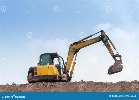 Excavator Digging and Loading Dirt at the Construction Site with Clear ...