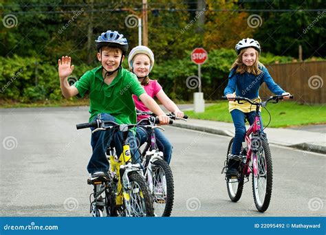 Happy Kids riding bikes stock photo. Image of energy - 22095492