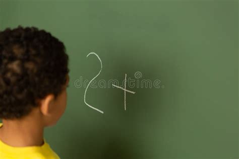 Schoolboy Doing Math on Greenboard in a Classroom Stock Image - Image ...