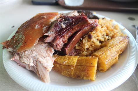 Lechon (roasted pig), plantain, rice and pigeon peas, blood sausage ...