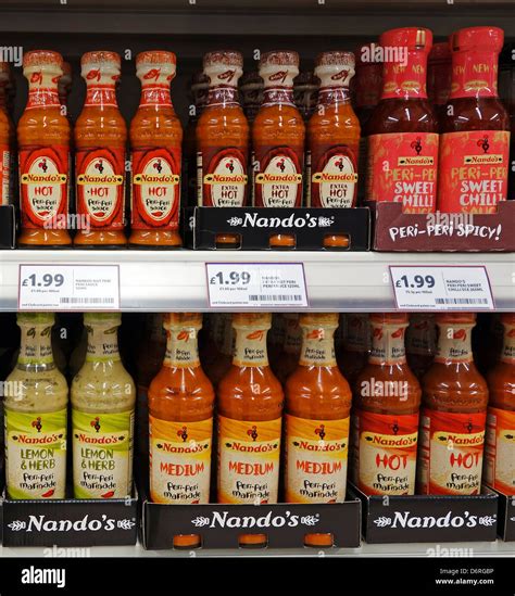 Bottles of nando's sauces in a UK supermarket Stock Photo - Alamy