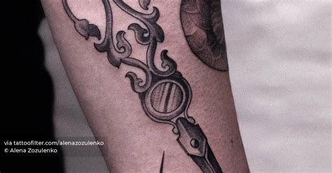 Vintage scissors tattooed on the forearm.