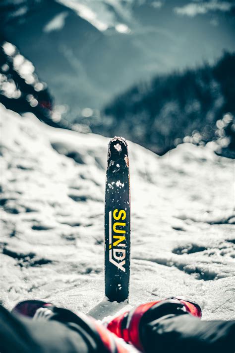 Black and White Snow Ski Board on Snow Covered Ground · Free Stock Photo