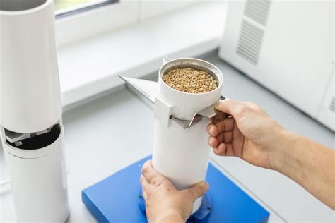 Premium Photo | Specialist sorts wheat grain in the laboratory quality ...