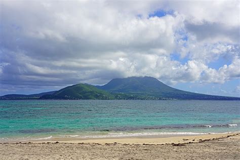 Day view of the Nevis Peak volcano across the water from St Kitts by EQ Roy. Photo stock - Snapwire