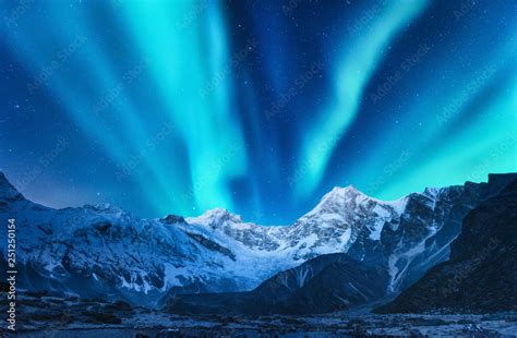 Aurora borealis above the snow covered mountain range in europe ...