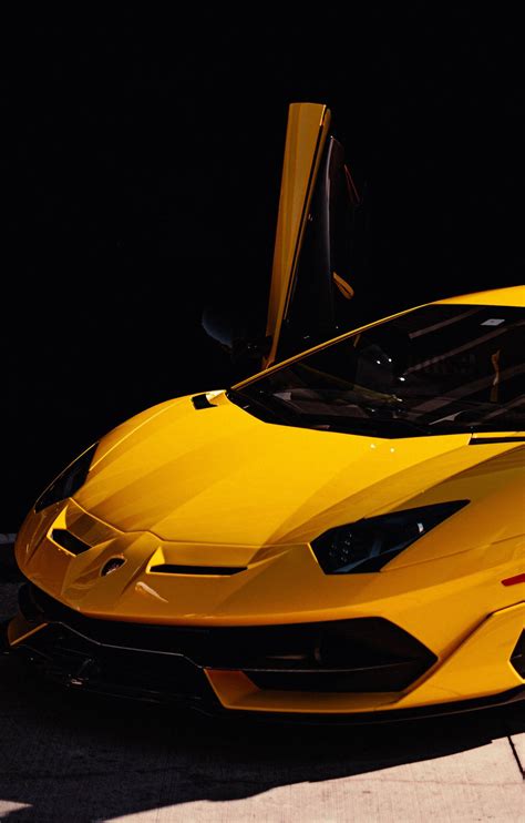 Download A Yellow Sports Car Wallpaper | Wallpapers.com