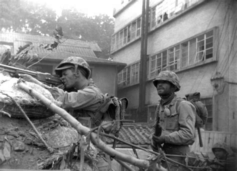 File:KOREAN CONFLICT- A soldier of the United Nations troops fires from behind a barricade at ...