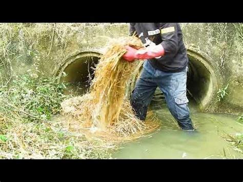 Unclogging Trash Clogged Culvert Drain Water - YouTube