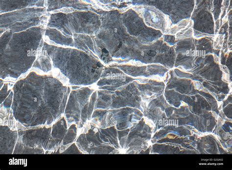 Water ripples in a pond and light reflections Stock Photo - Alamy