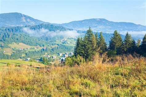 Premium Photo | Autumn countryside landscape with village on mountainside