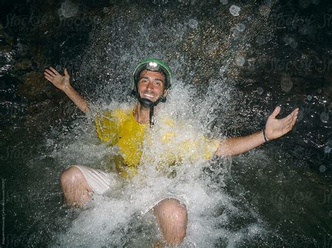 "Spelunker Man Under A Waterfall On An Underground River Inside A Cave" by Stocksy Contributor ...