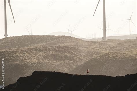 Pulled back view of a woman silhouette running on rocky landscape Stock Photo | Adobe Stock