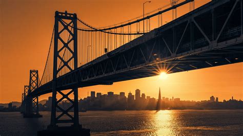 Download San Francisco Skyline With Sunset Bridge Wallpaper | Wallpapers.com