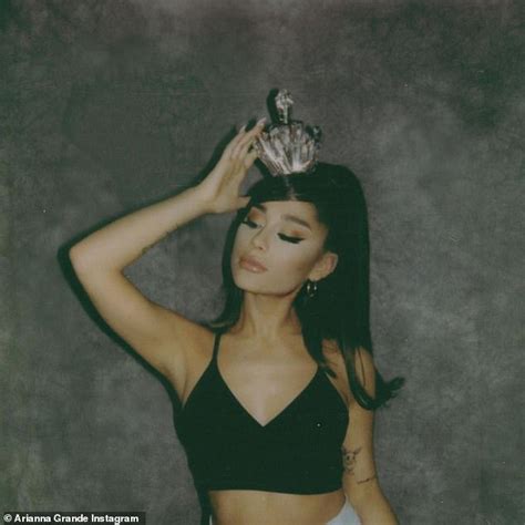 Ariana Grande dazzles in black sports bra... as she promotes her newly ...