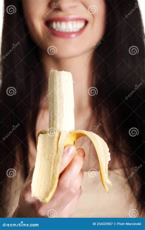 Beautiful Young Woman Is Eating Banana. Royalty Free Stock Photography - Image: 25433907