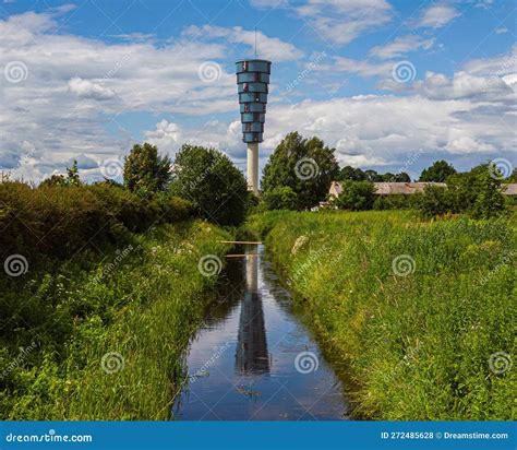 Modern Urban Architecture. Water Tower. Reflection in Water. Green Grass and Bushes. Sunny Day ...