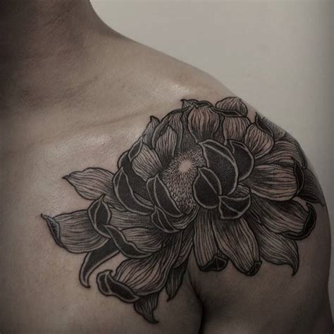 Chrysanthemum tattoo on the left shoulder.