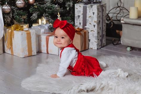 Premium Photo | Beautiful baby girl in red dress smiling at the camera