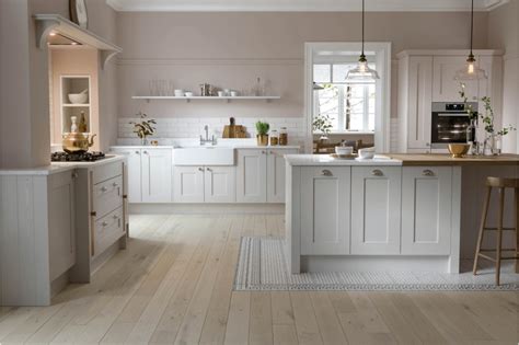 a large kitchen with white cabinets and wood flooring on the walls is pictured in this image