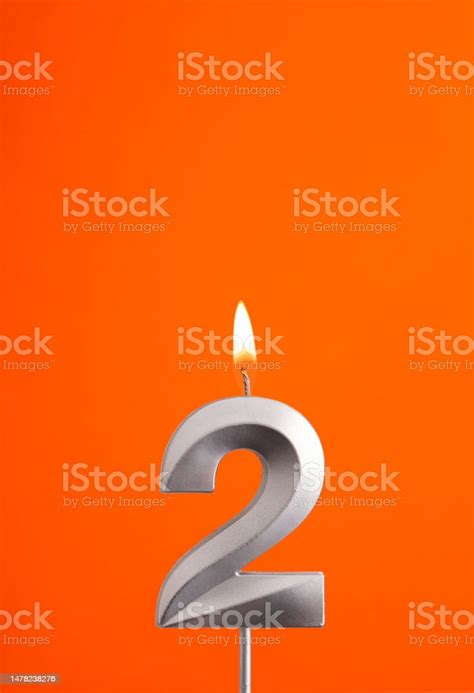 Number 2 Burning Anniversary Candle On Orange Foamy Background Stock ...