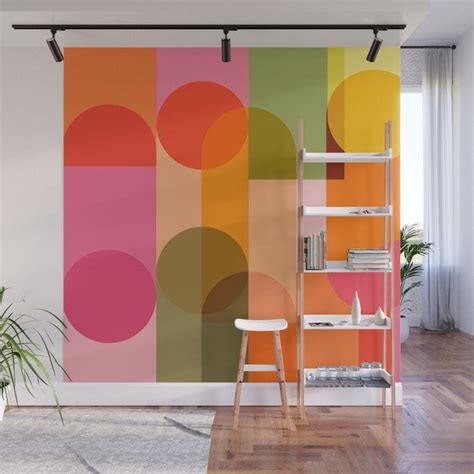 an abstract wall mural with colorful circles on it in a modern living room or office space