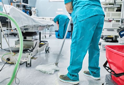 Premium Photo | Woman cleaning staff mopping the floor of a hospital operating room