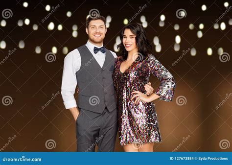 Happy Couple Hugging at Party Over Garland Lights Stock Photo - Image of multiethnic, fashion ...