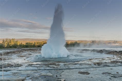 Geysir erupting at sunset in the Golden Circle area of Iceland Stock ...