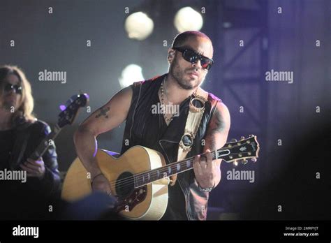 Lenny Kravitz shows off his tattoos in a sleeveless leather vest as he ...