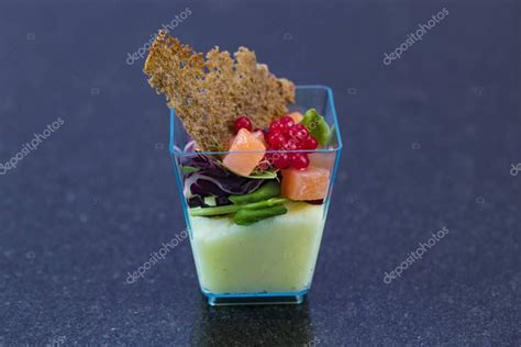 a small glass cup filled with food on top of a table stock photo 1049782