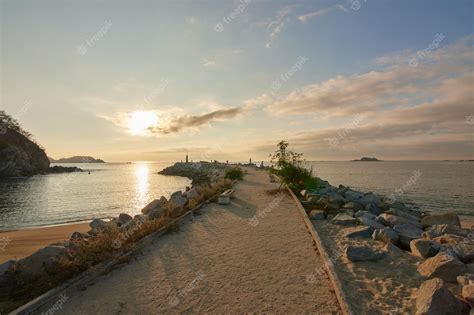 Premium Photo | A beach with a lighthouse in the distance