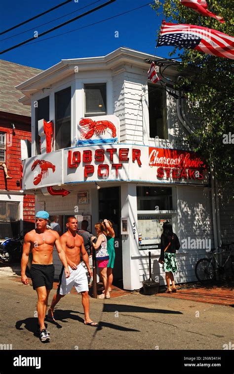 Two men enjoy the summer weather strolling through Provincetown, on ...