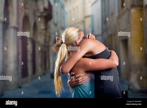 Young couple hug in sunset street Stock Photo - Alamy