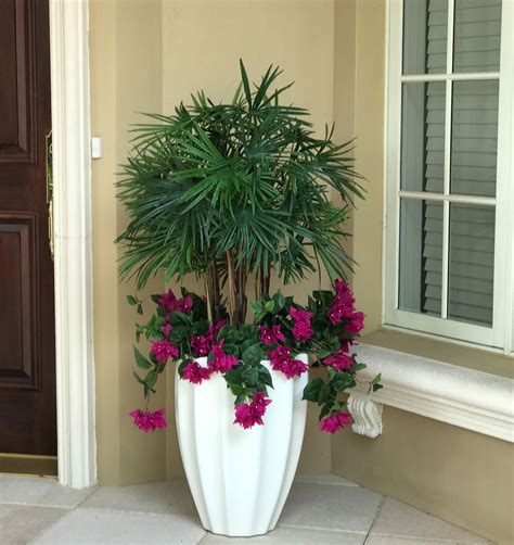 A permanent botanical Lady Finger palm underplanted with outdoor silk bougainvillea, in a ...