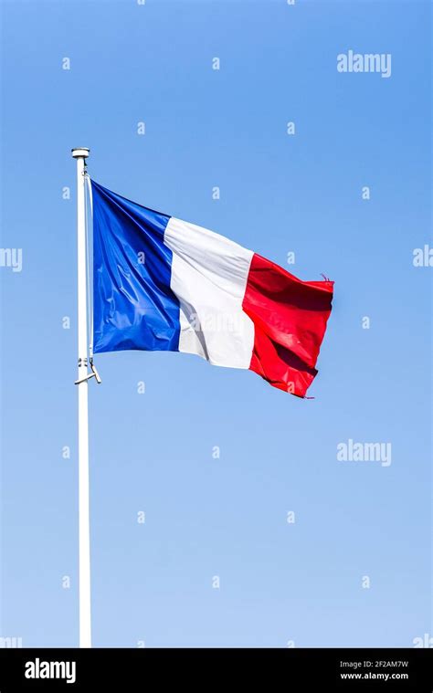 French flag waving in the wind on a sunny day Stock Photo - Alamy