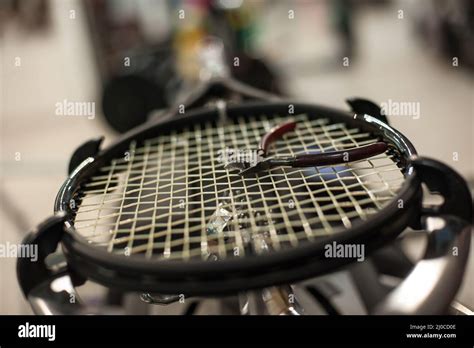 Racket stringing. Detail of tennis racket in the stringing machine Stock Photo - Alamy